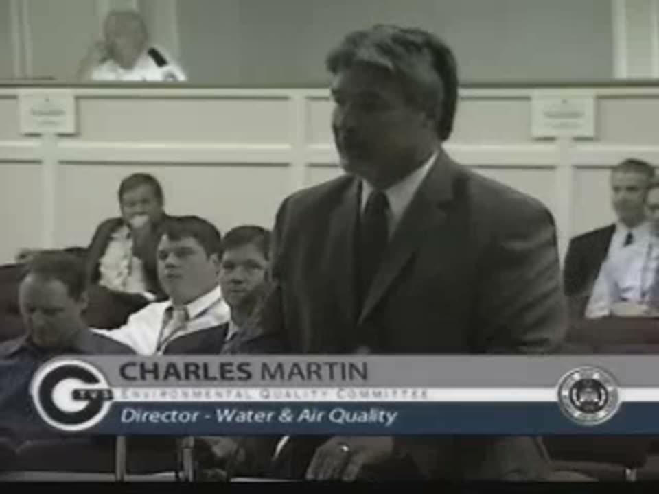 Charlie Martin at a 2011 special Environmental Quality Committee meeting presenting the ten-year financial model and remedial measures capital improvement plan, with a slide visible behind him