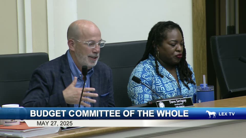 Council Member Dave Sevigny of Lexington's 10th District speaks at the dais during the May 27, 2025 Budget Committee of the Whole, with his name plate reading 'Dave Sevigny (he/him) 10th District' clearly visible.