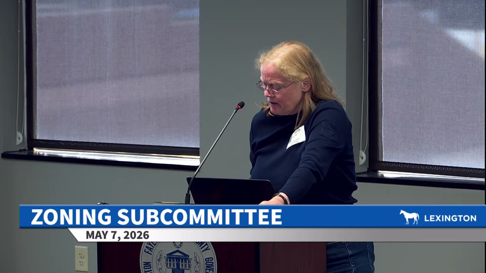 Amy Clark at the public-comment podium.