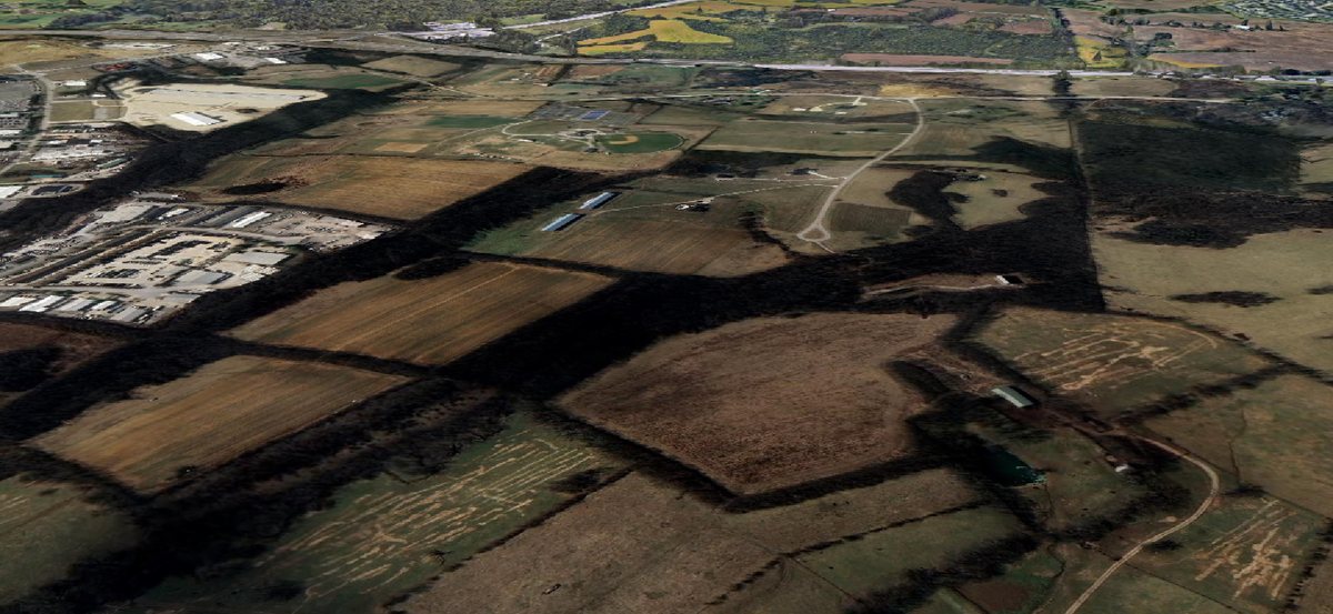 Aerial 3D view of the Blue Sky industrial area beside Interstate 75, surrounded by farmland