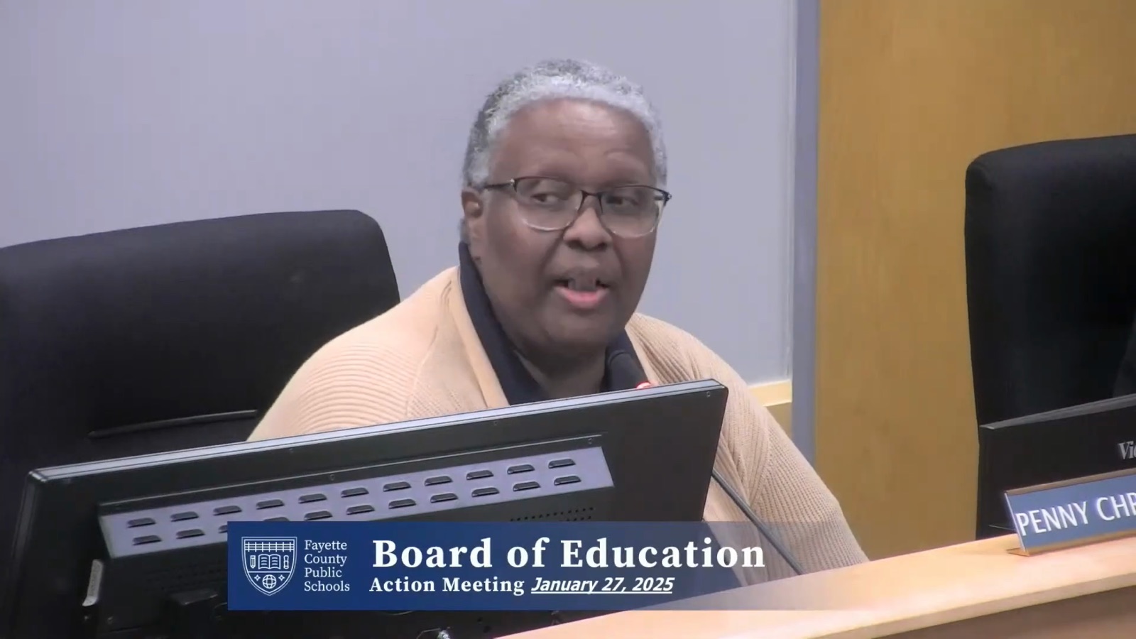Board member Penny Christian speaking at the dais