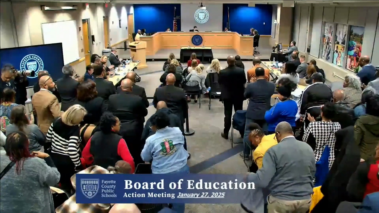 The board room crowd after the 3-2 vote, some attendees standing