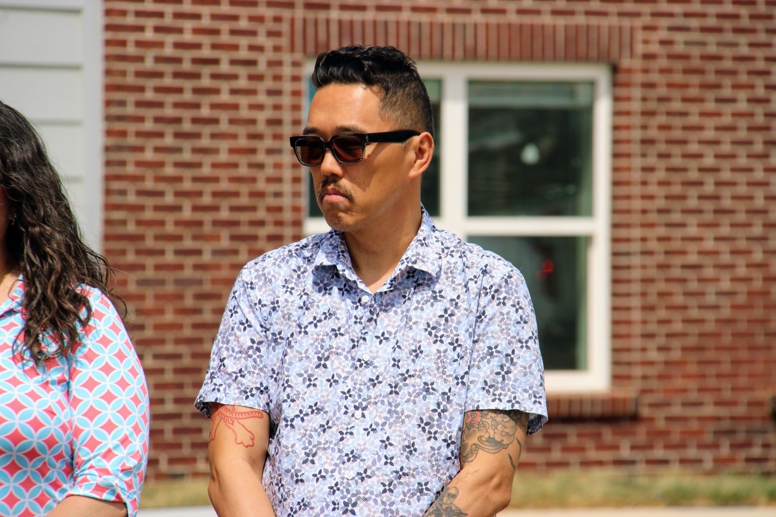Vice Mayor Dan Wu at a Lexington outdoor event in spring 2026, in sunglasses and a blue and white floral short-sleeve shirt