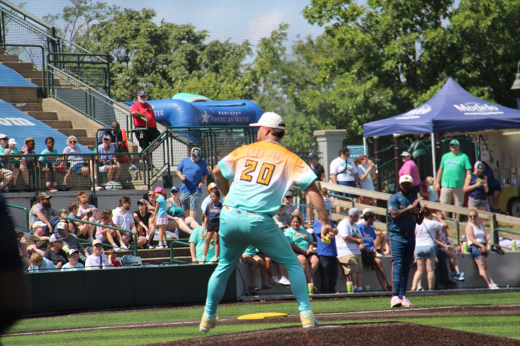 A Coconuts pitcher delivers in front of the first-base stands.