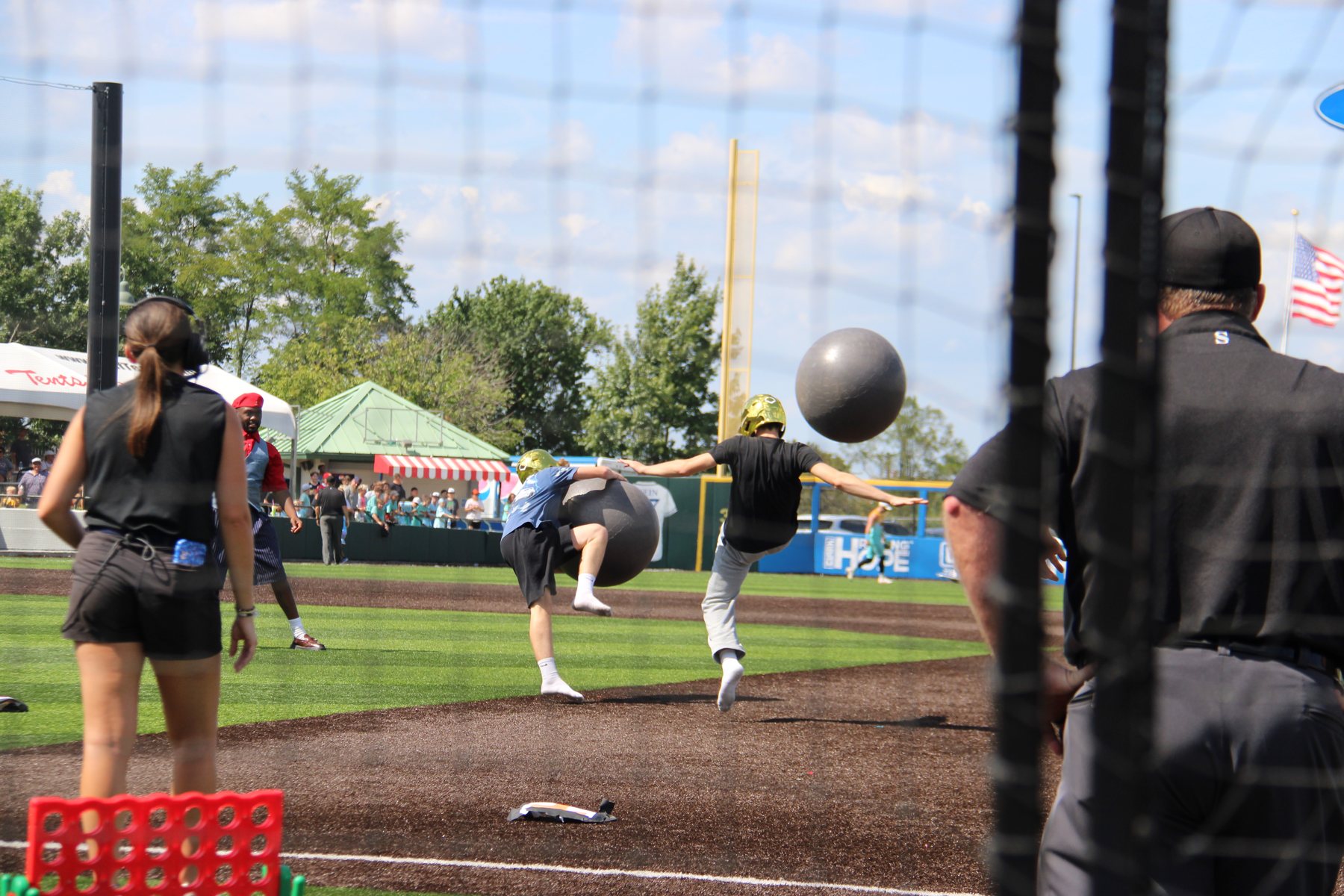Fans kick yoga balls down the first-base line in an in-game contest.